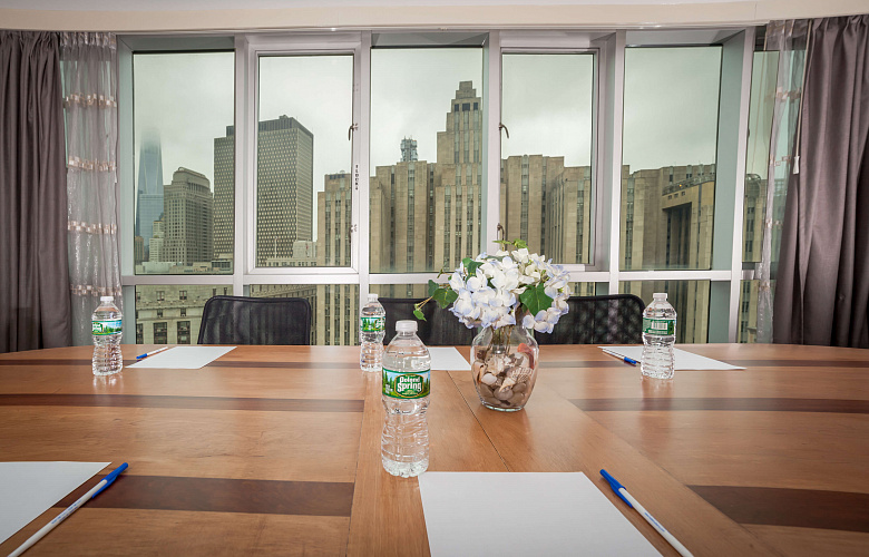 Photo 1 of Meeting Room with a view of NYC that can accommodate up to 8 people and including amenities, such as TV, coffee/tea/water and Wifi. 