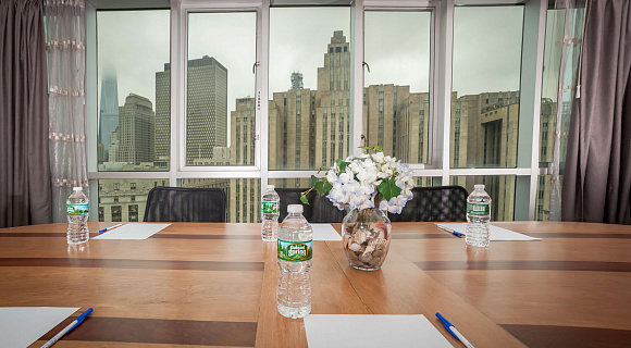 Photo 1 of Meeting Room with a view of NYC that can accommodate up to 8 people and including amenities, such as TV, coffee/tea/water and Wifi. 