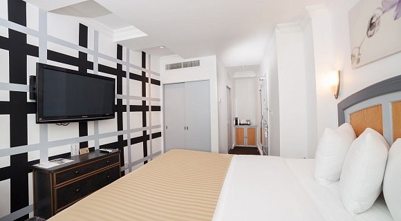 Photo 1 of Deluxe King Room with City View with a  king sized bed, view of the lower west side, and all the standard amenities.